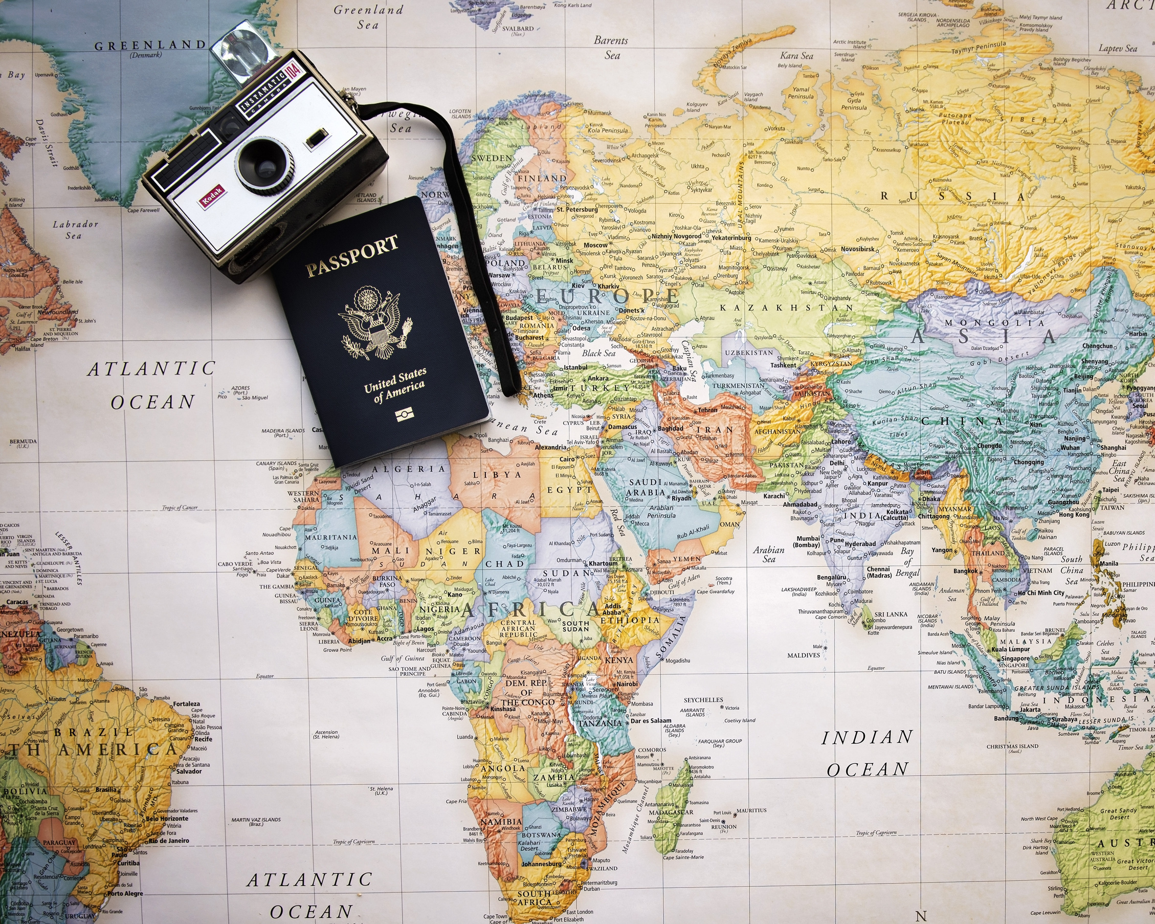 Passport and Vintage Camera on a World Map